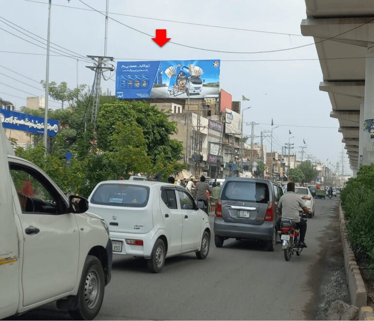 Busy traffic at Multan Chungi Road Lahore with roadside advertising billboard